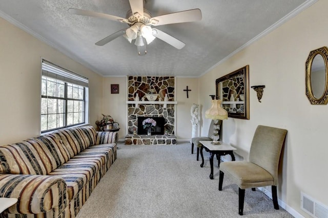 living room with a textured ceiling, a fireplace, carpet flooring, visible vents, and crown molding