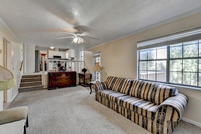 living room with crown molding, a wealth of natural light, and light colored carpet