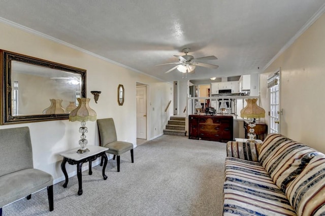 living room featuring ceiling fan, light colored carpet, baseboards, ornamental molding, and stairway