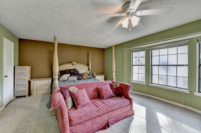 bedroom with carpet, baseboards, ceiling fan, and a textured ceiling