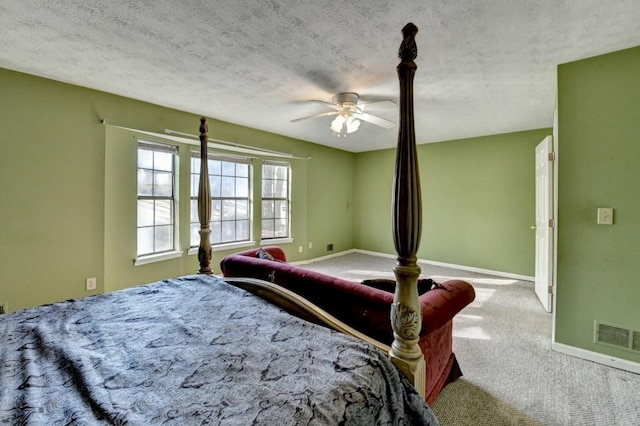 carpeted bedroom featuring visible vents, ceiling fan, a textured ceiling, and baseboards