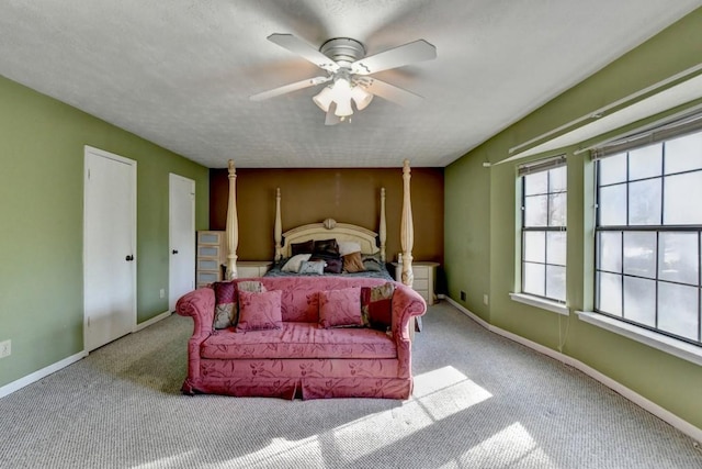 bedroom with carpet floors, a textured ceiling, and baseboards