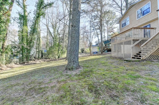 view of yard featuring stairway and a deck