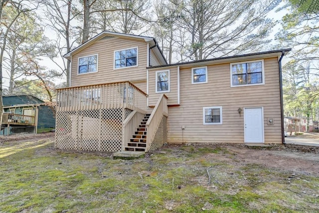 rear view of house featuring stairway and a wooden deck