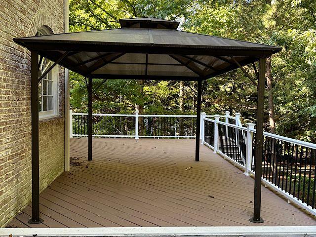 wooden terrace featuring a gazebo