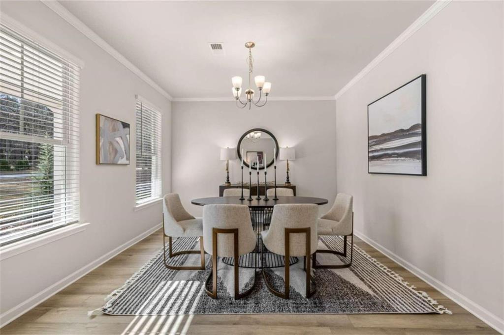 4517 Ajo Walk, Atlanta, GA 30331 - kitchen featuring tasteful backsplash, a kitchen breakfast bar, visible vents, appliances with stainless steel finishes, and a sink