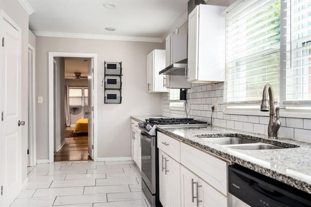 kitchen with sink, light stone countertops, white cabinets, and appliances with stainless steel finishes