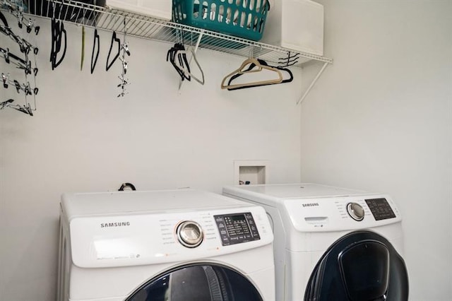 washroom featuring washing machine and clothes dryer