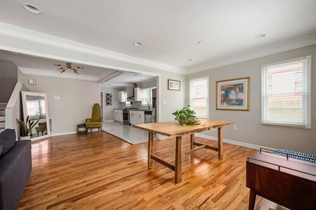 dining area featuring ornamental molding and light hardwood / wood-style floors