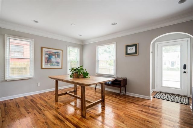 dining room with light hardwood / wood-style flooring and ornamental molding