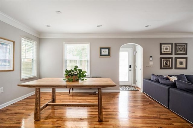 dining space with hardwood / wood-style flooring and ornamental molding