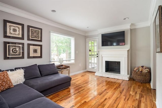 living room featuring ornamental molding and light hardwood / wood-style flooring