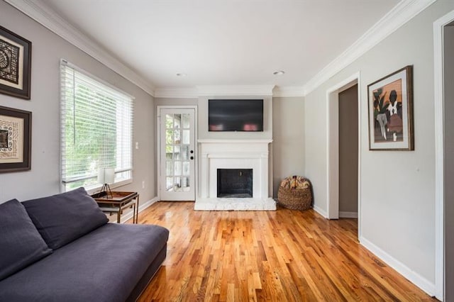 living room featuring crown molding and light hardwood / wood-style floors