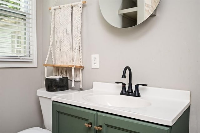 bathroom featuring a healthy amount of sunlight, toilet, and vanity