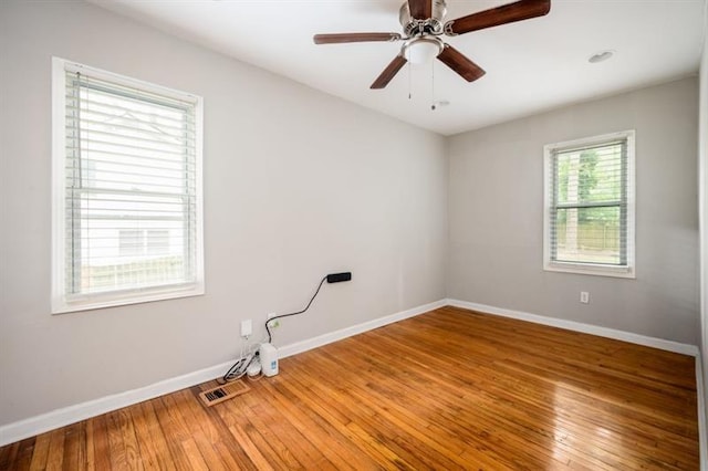 spare room with hardwood / wood-style flooring and ceiling fan