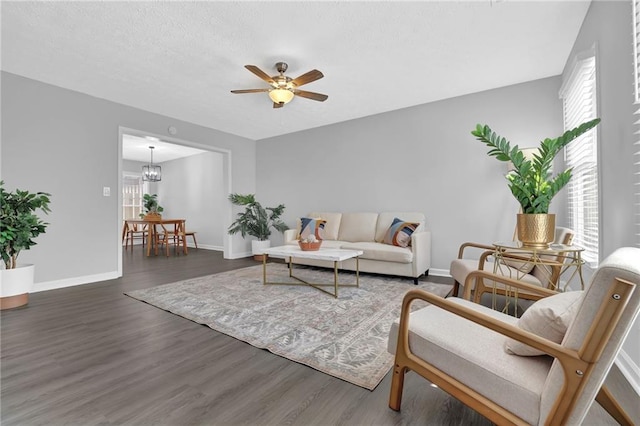 living room with dark hardwood / wood-style flooring and ceiling fan