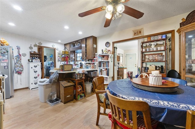 dining area with ceiling fan, a textured ceiling, light wood-type flooring, and recessed lighting