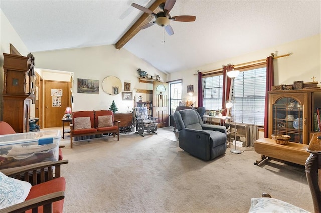 carpeted living room featuring a ceiling fan, lofted ceiling with beams, and a textured ceiling