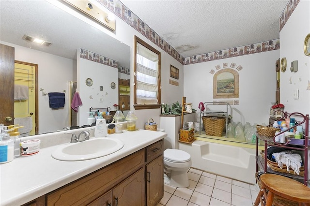 bathroom featuring toilet, tile patterned floors, a textured ceiling, a tub, and vanity