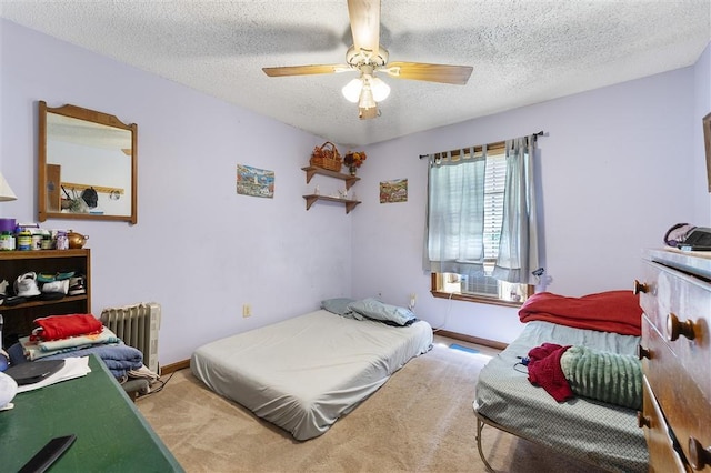 bedroom with radiator, a textured ceiling, ceiling fan, and carpet floors