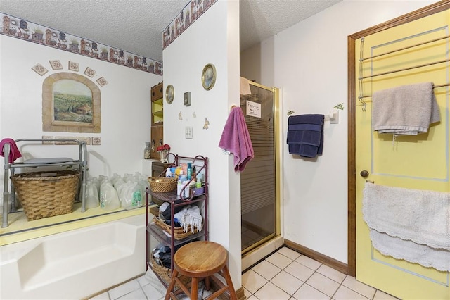 full bathroom with a stall shower, tile patterned flooring, and a textured ceiling