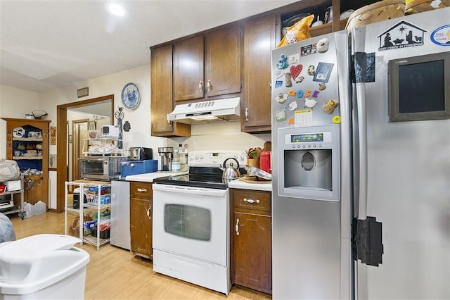 kitchen featuring under cabinet range hood, white range with electric stovetop, stainless steel refrigerator with ice dispenser, light wood-style floors, and light countertops