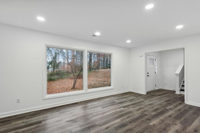 interior space with a healthy amount of sunlight and dark hardwood / wood-style flooring