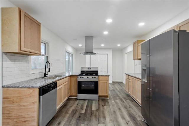 kitchen with stainless steel appliances, sink, island range hood, and light stone counters