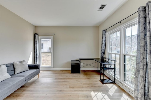 interior space with visible vents, baseboards, and light wood finished floors