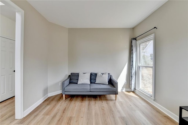 sitting room with baseboards and wood finished floors