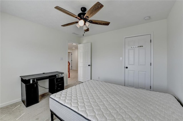 bedroom featuring light colored carpet, baseboards, and ceiling fan