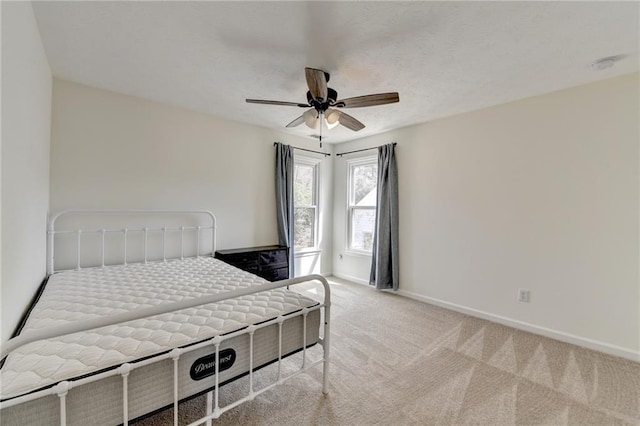 bedroom featuring a ceiling fan, baseboards, and carpet floors