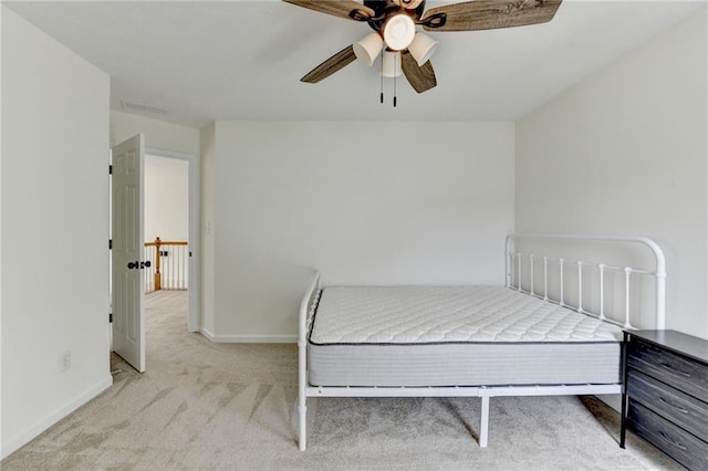 carpeted bedroom featuring visible vents, baseboards, and ceiling fan