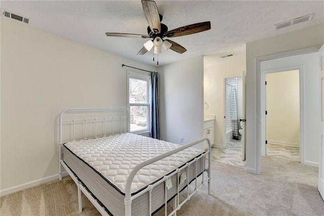 bedroom featuring visible vents and light carpet