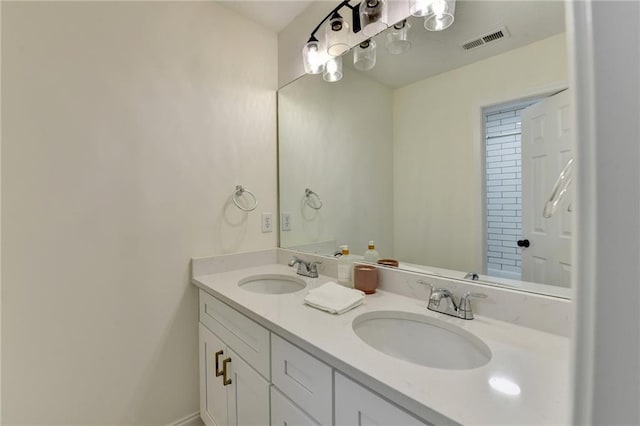 full bathroom with double vanity, visible vents, baseboards, and a sink