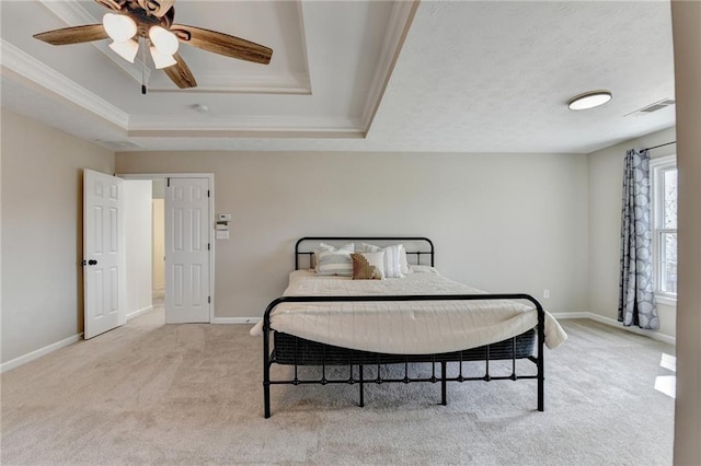 carpeted bedroom featuring visible vents, ceiling fan, baseboards, a tray ceiling, and a textured ceiling