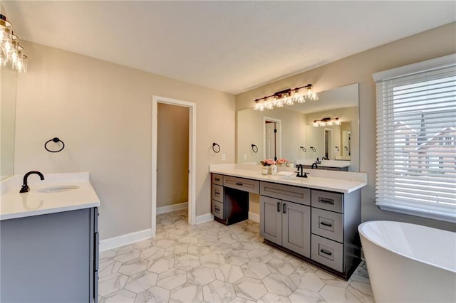 bathroom with a soaking tub, two vanities, and a sink