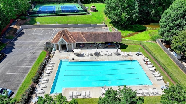 view of pool with a patio area and fence