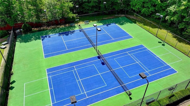 view of sport court featuring fence