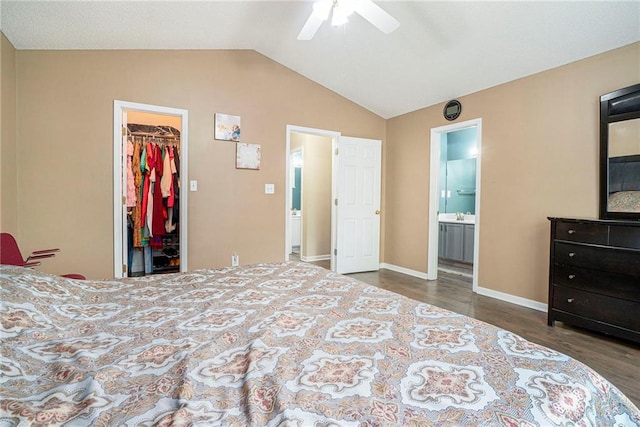 bedroom with a spacious closet, wood finished floors, lofted ceiling, a closet, and ensuite bath
