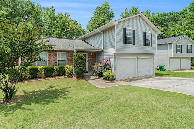 split level home featuring a garage, concrete driveway, a front lawn, and brick siding