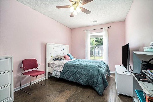 bedroom featuring a textured ceiling, wood finished floors, a ceiling fan, and baseboards
