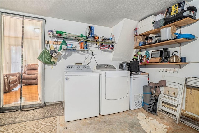 washroom featuring independent washer and dryer and a textured ceiling