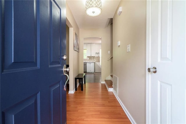 foyer featuring light wood-type flooring and baseboards