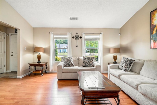 living area featuring light wood-type flooring and baseboards