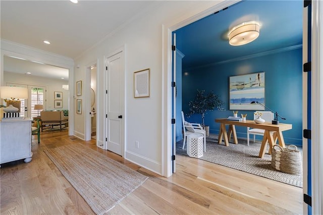hall featuring recessed lighting, crown molding, baseboards, and wood finished floors