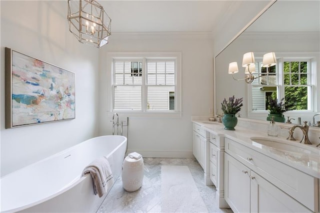 full bathroom with a sink, a notable chandelier, ornamental molding, and double vanity
