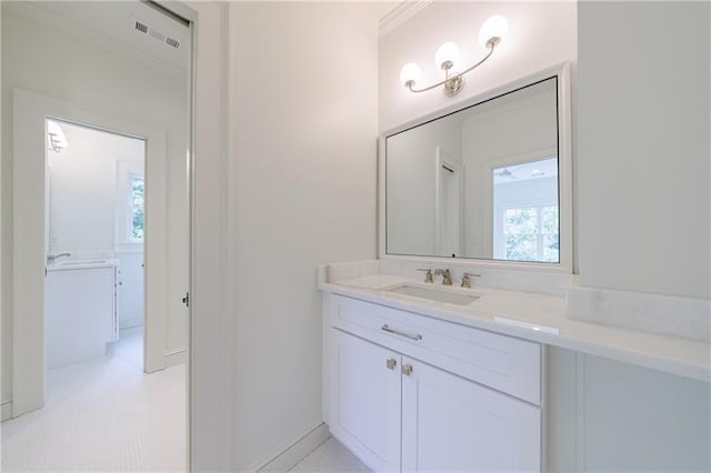 bathroom with visible vents, ornamental molding, and vanity