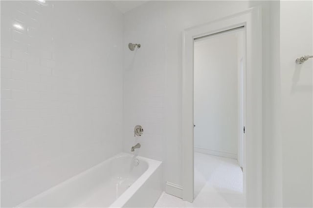 bathroom featuring baseboards and bathing tub / shower combination