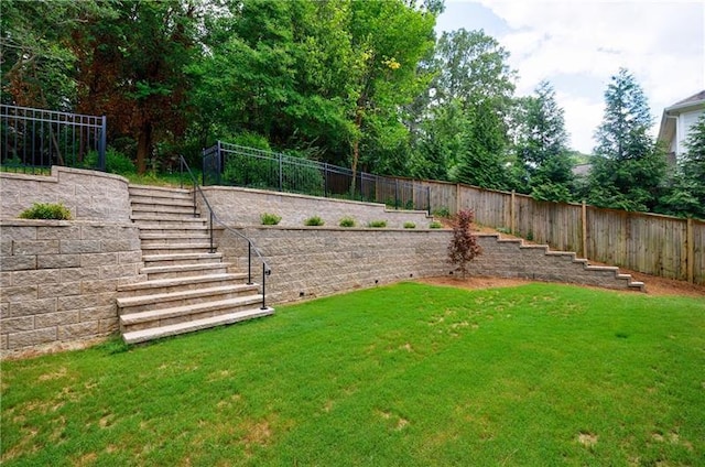 view of yard with stairway and a fenced backyard